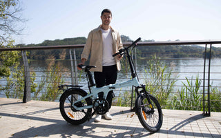 Commuter riding a folding e-bike through a UK city during a long cross-city commute, demonstrating efficient urban travel.