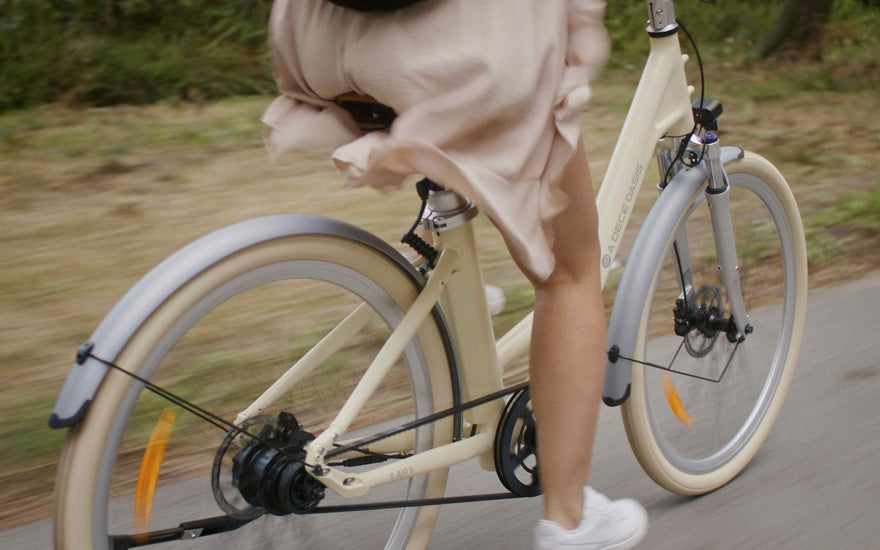 Urban electric bike complying with UK 250W EAPC regulations being ridden on a city street.