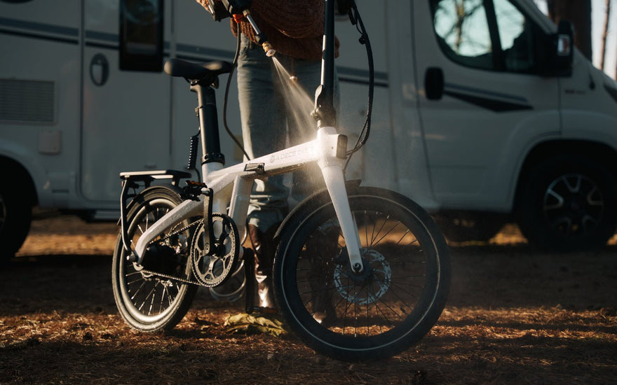 A close-up of the ADO Air Carbon Pro being washed. As the lightest folding e-bike in the UK, its high-quality carbon fibre frame is naturally corrosion-resistant, making it perfect for daily commutes in rainy British weather.