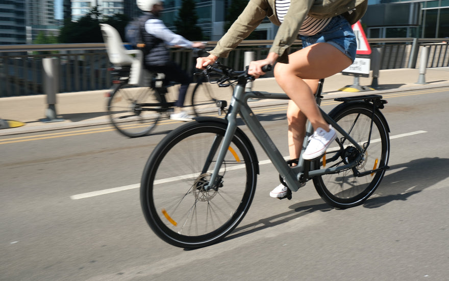 Urban rider using an EAPC-compliant e-bike with integrated GPS on a city street in the UK