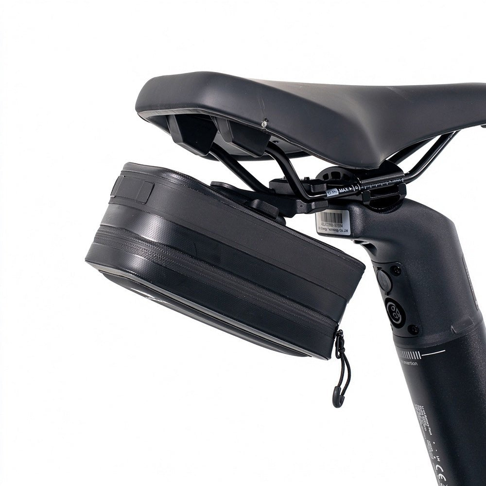 The black ADO CB11 bicycle saddle bag securely mounted under the bike seat using the AQS Mag quick-release system, offering compact storage for your ride.