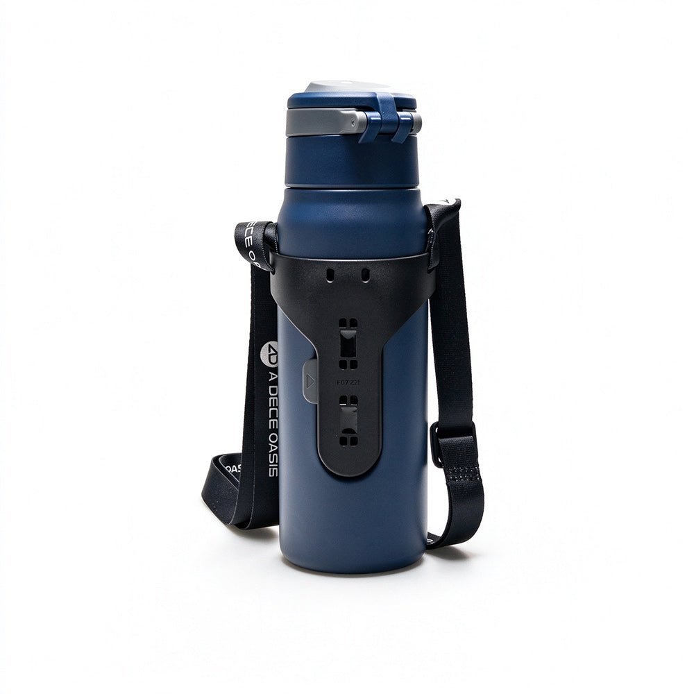 Rear view of the dark blue ADO insulated bottle showing the integrated AQS Mag quick-release interface and the black adjustable carry strap.Dark blue